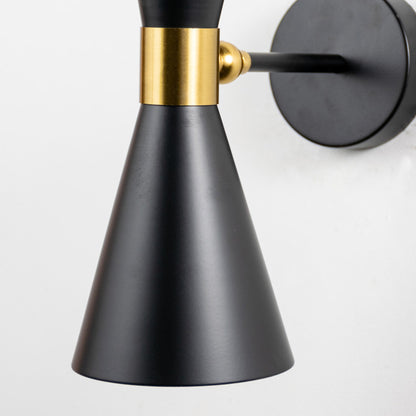 Modern black metal spotlight wall light with brass accents for elegant contemporary interior decor.