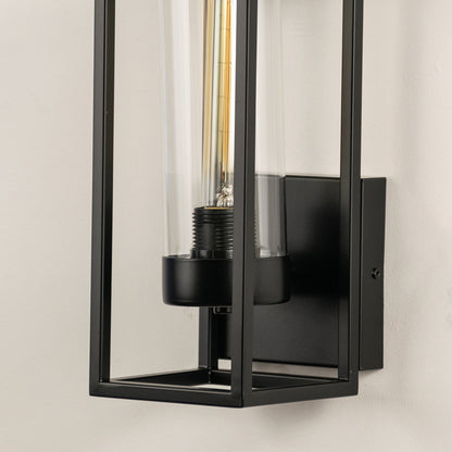 Modern wall light with black metal frame and exposed bulb on neutral background minimal industrial lighting for bedroom decor.