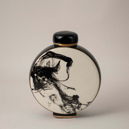 Elegant black and white ceramic vase with hand-painted ink art captured on white background for interior decoration.