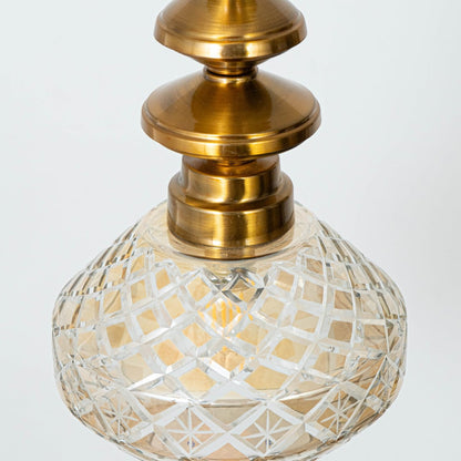 Detailed view of patterned glass and gold metal pendant light showcasing artistic craftsmanship.