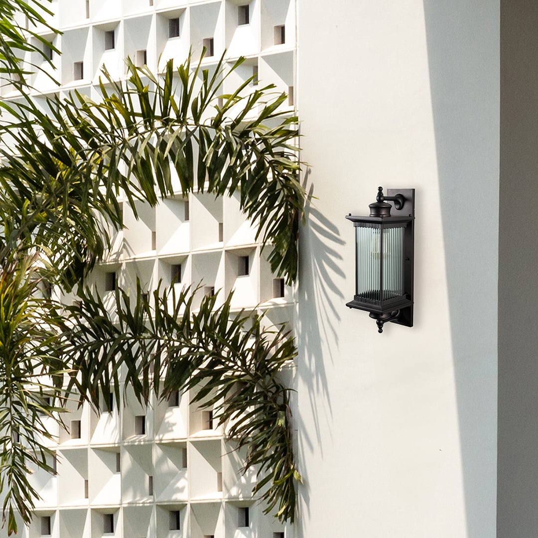 Black metal outdoor wall light lifestyle image on modern exterior wall for stylish patio lighting decor.