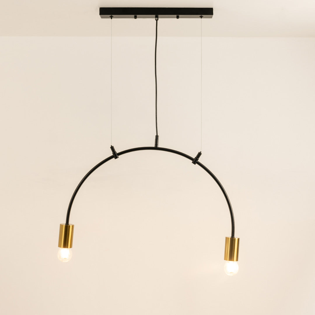 Black and gold metal arc pendant light with illuminated tube shades creating modern ambient ceiling lighting indoors.