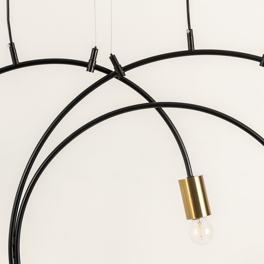 A closeup view of the chandelier showing the smooth black metal arcs and gold bulb holders highlighting premium craftsmanship and modern design details.