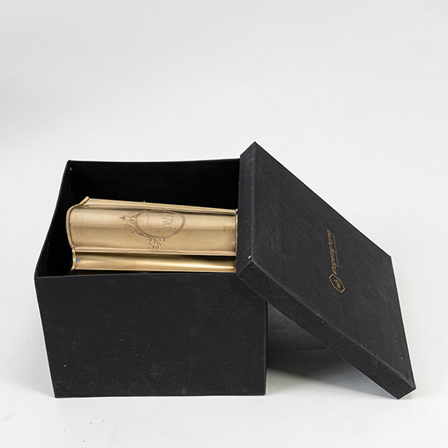 Gold planter with embossed design and side handles placed on white background highlighting shine and shape clearly.