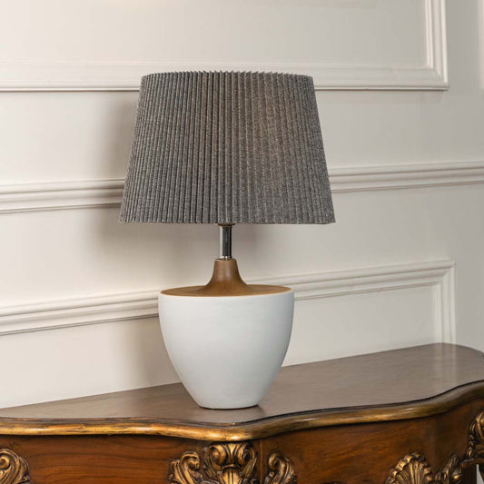 Grey ceramic table lamp with pleated fabric shade and bowl shaped base designed for sophisticated modern table lighting.