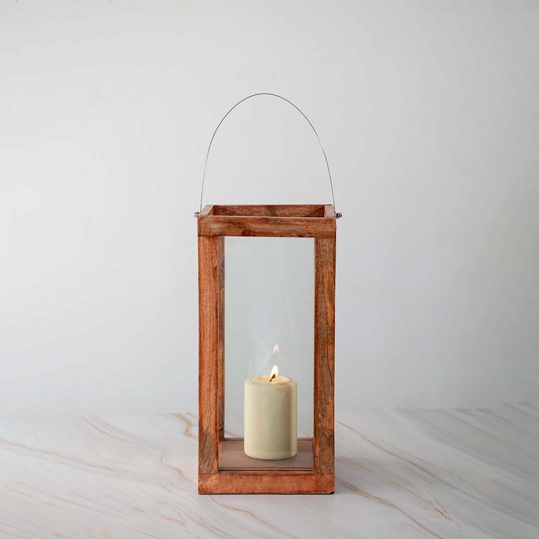 Wooden lantern illuminated with candlelight against a clean white background showcasing its minimalist design.