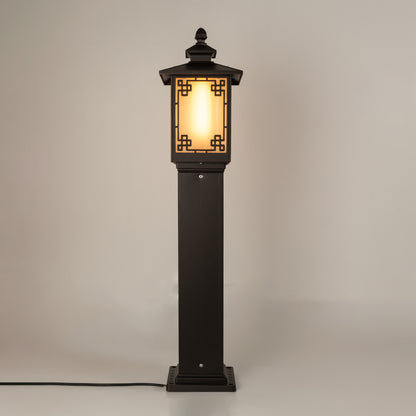 Vintage black outdoor gate light with warm glowing panels for elegant exterior decor use.