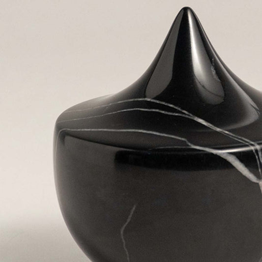 Black marble decorative sculpture with cone silhouette for elegant shelf styling and contemporary home decor displays.
