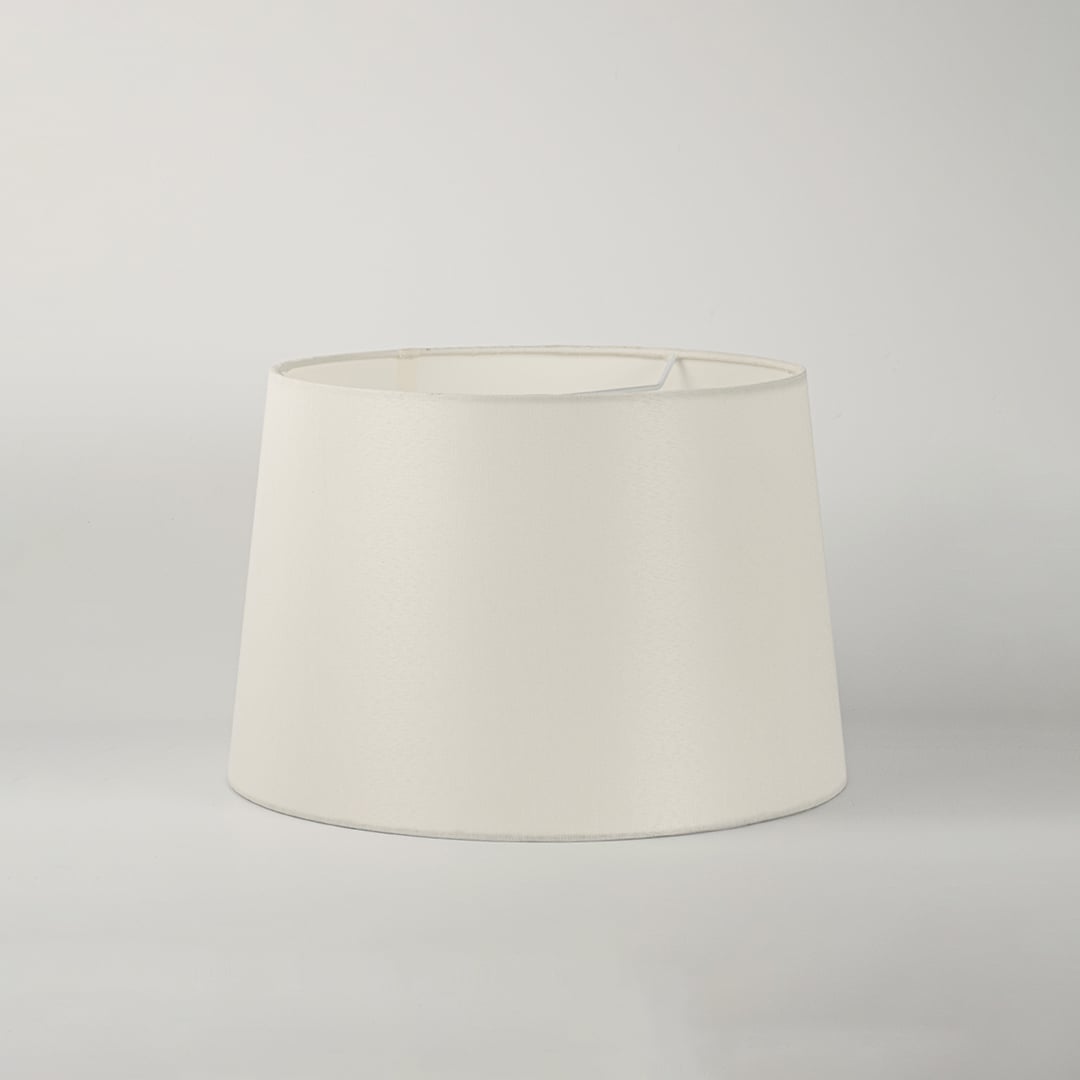 White round tapered lamp shade on plain background shown in close up view for elegant minimal lighting décor.