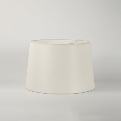 White round tapered lamp shade on plain background shown in close up view for elegant minimal lighting décor.