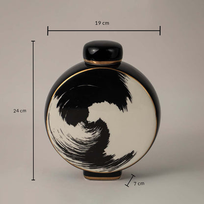 Black and beige ceramic vase with swirl design showing 24 cm height 19 cm width and 7 cm depth on white background.