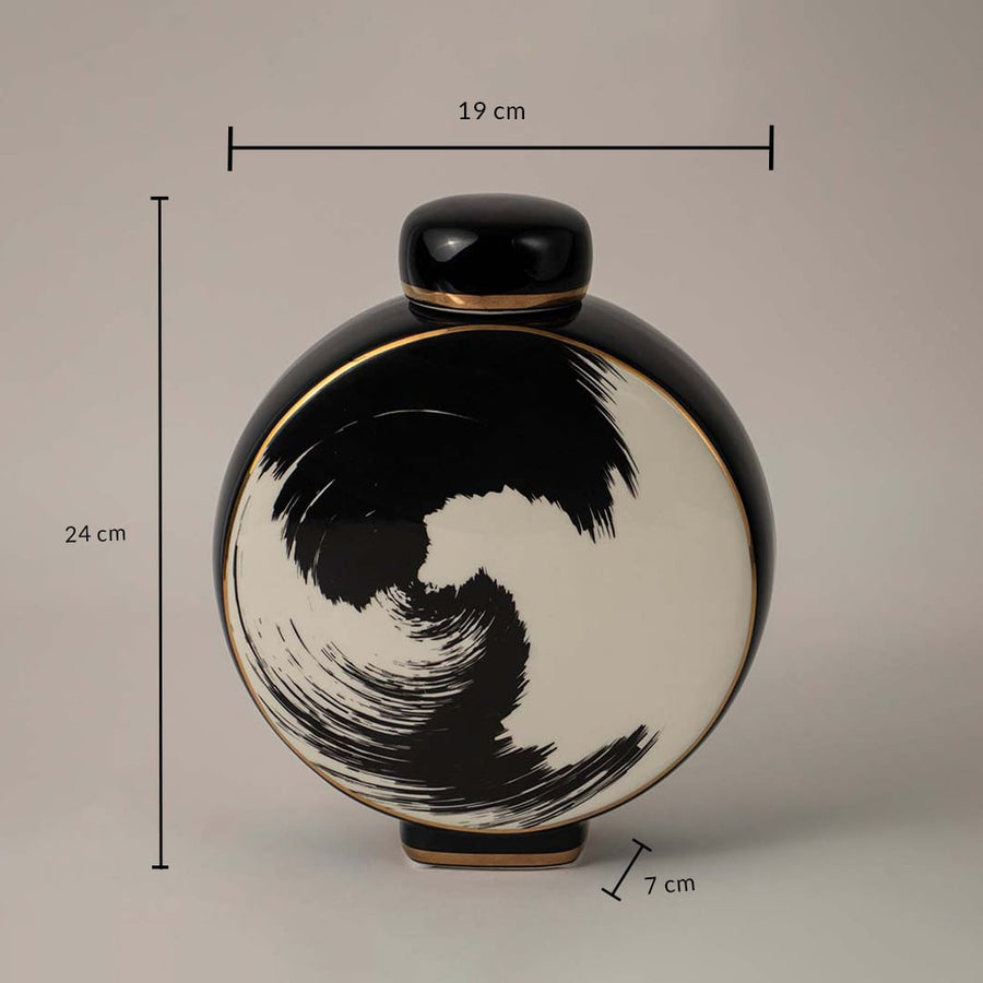 Black and beige ceramic vase with swirl design showing 24 cm height 19 cm width and 7 cm depth on white background.
