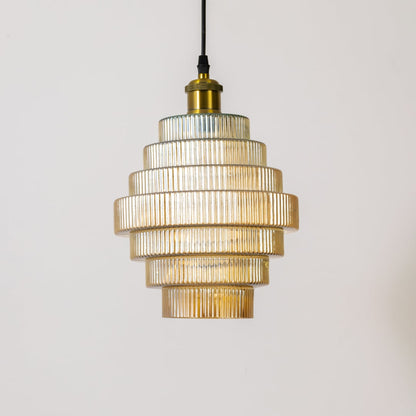 Gold metal pendant light with layered clear glass shades illuminated to highlight modern design.