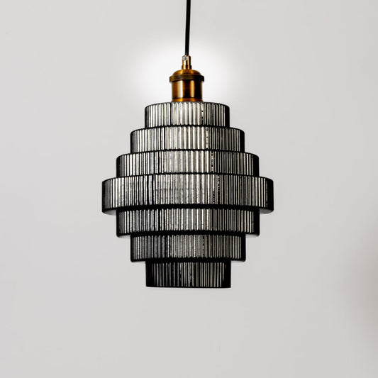 Black metal pendant light with layered smoke glass shades illuminated to showcase luxury ceiling lighting.