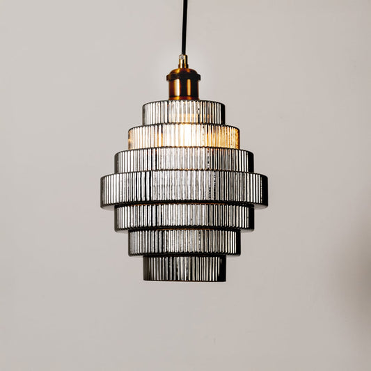 Black metal pendant light with layered glass shades illuminated to showcase luxury ceiling lighting.