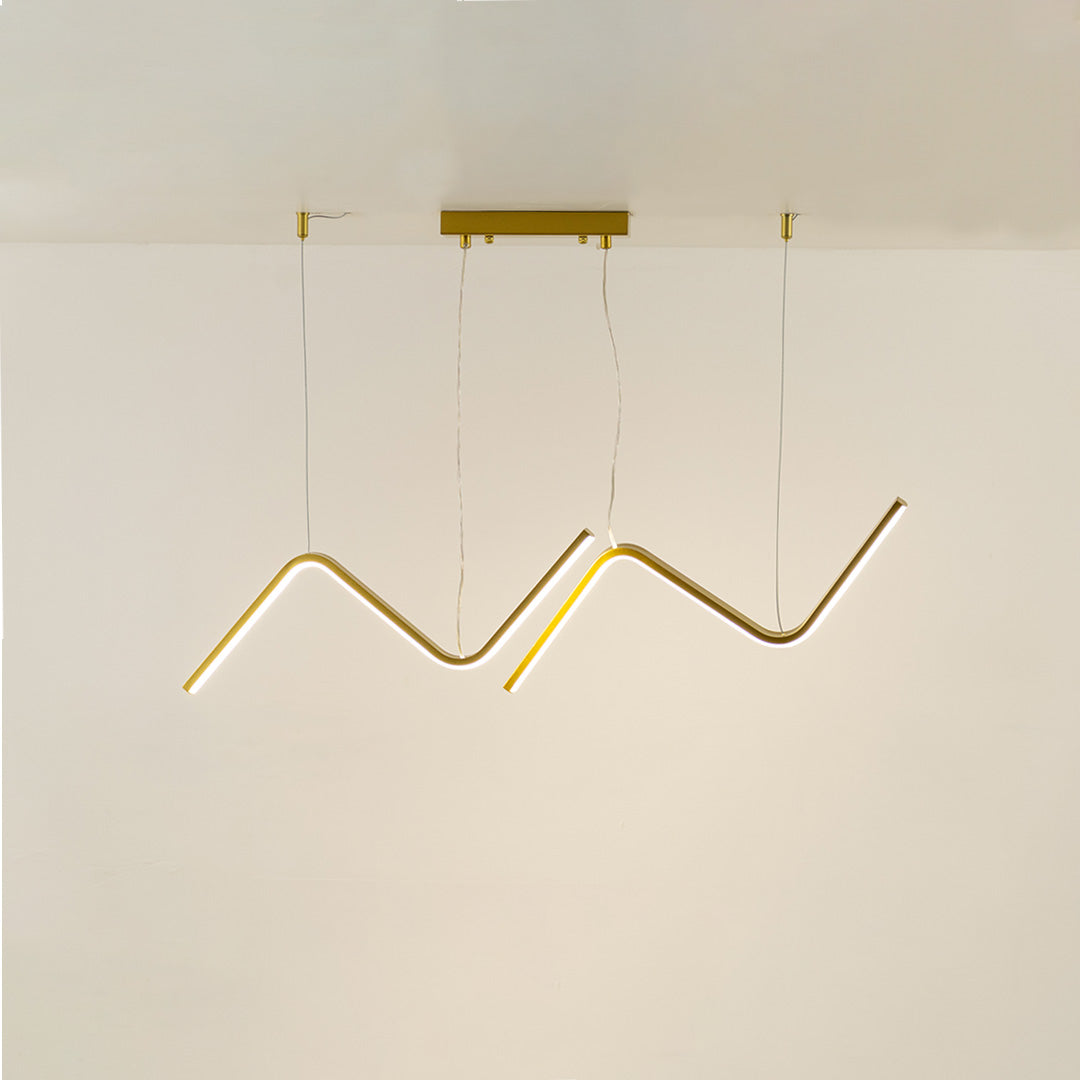 Gold metal zigzag LED pendant light with integrated illumination creating artistic modern ceiling lighting indoors.
