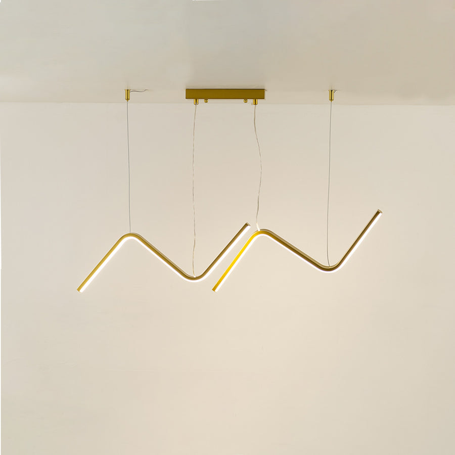 Gold metal zigzag LED pendant light with integrated illumination creating artistic modern ceiling lighting indoors.