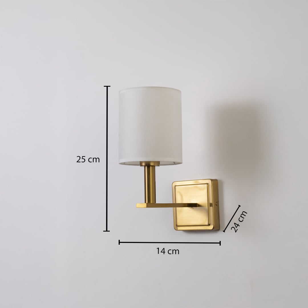 Gold wall sconce with white drum shade shown with 25 cm height 14 cm width and 24 cm depth for accurate placement.
