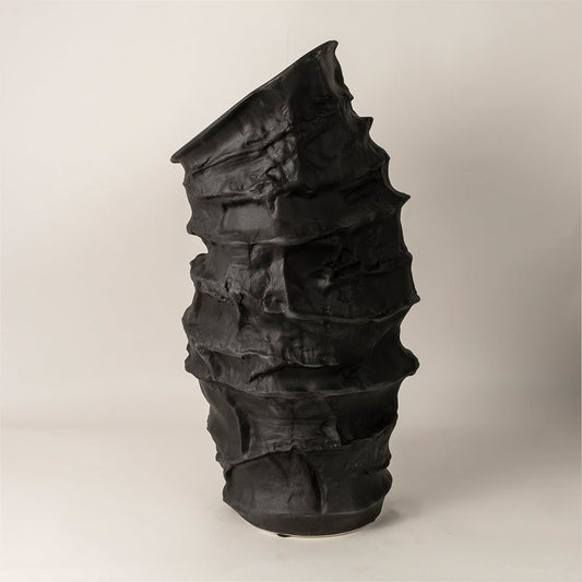 Side view of Eclipse black ceramic vase revealing its organic asymmetric form and detailed sculptural craftsmanship ideal for modern decor.