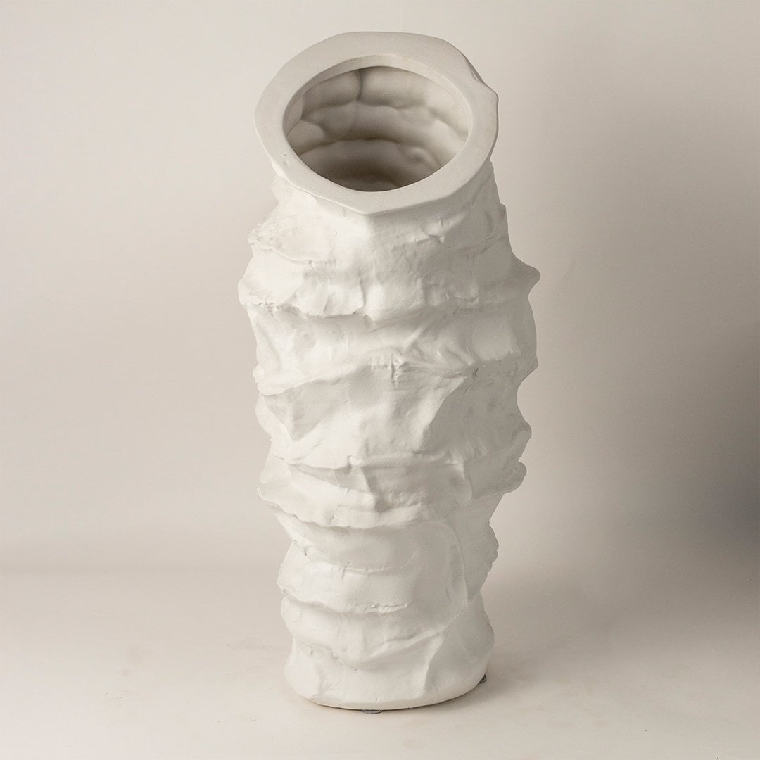 Eclipse white ceramic vase displayed on a plain background showcasing its tall handcrafted layered design and artistic matte texture.