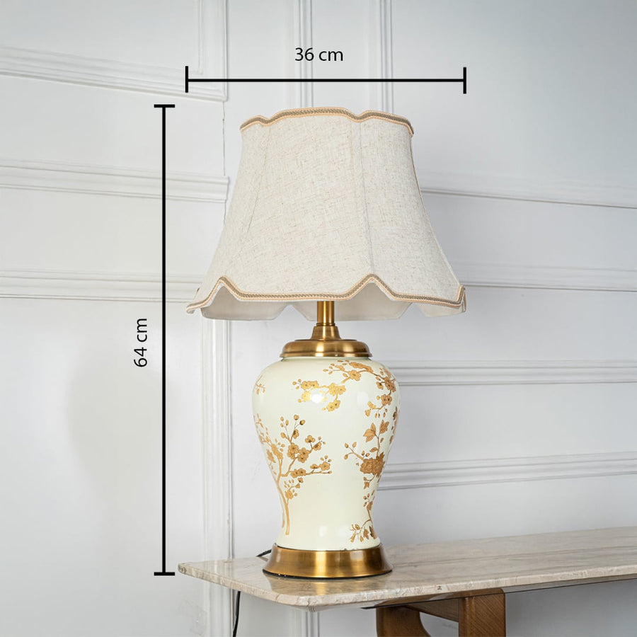 Table lamp with cream ceramic base and fabric shade shown with 36 cm width and 64 cm height for accurate decor placement.