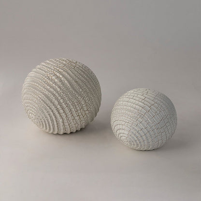 Set of white textured decorative spheres for elegant shelf styling and contemporary home decor arrangements.