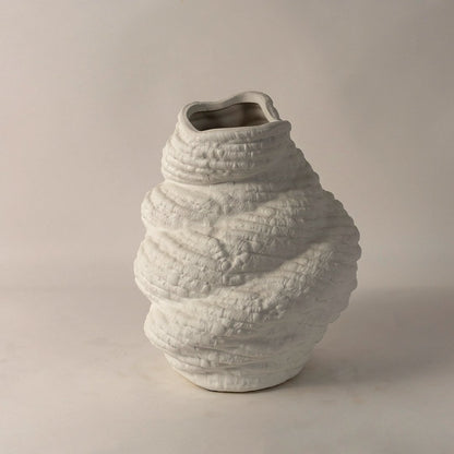 Side angle view of white ceramic sculptural vase with textured body and artistic curves perfect for unique contemporary decor.