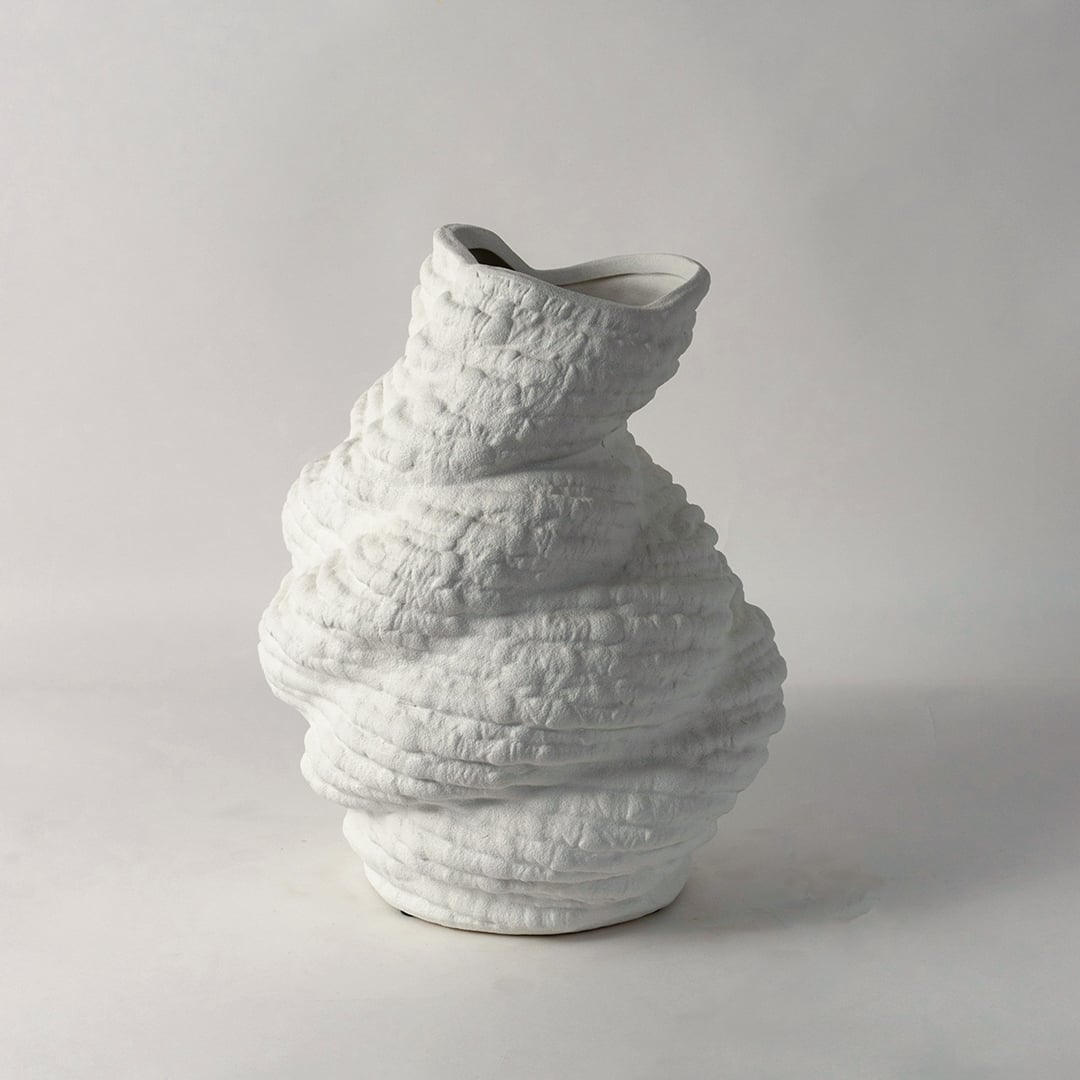 Contemporary white ceramic vase with bold sculptural form and unique textured surface ideal for stylish interior decoration.