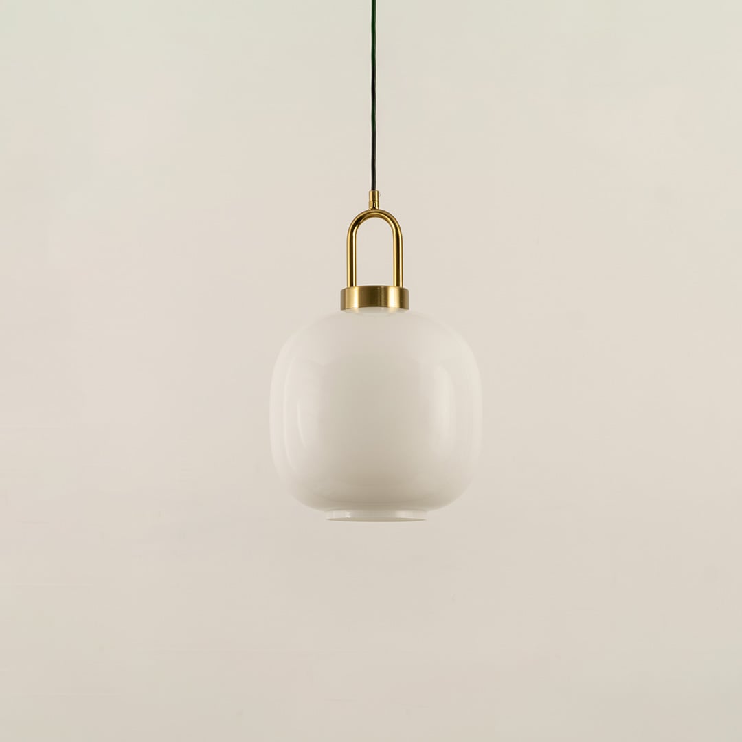 A gold and white glass pendant light with lights off on a white background highlighting its smooth rounded glass shade and refined metal accents.