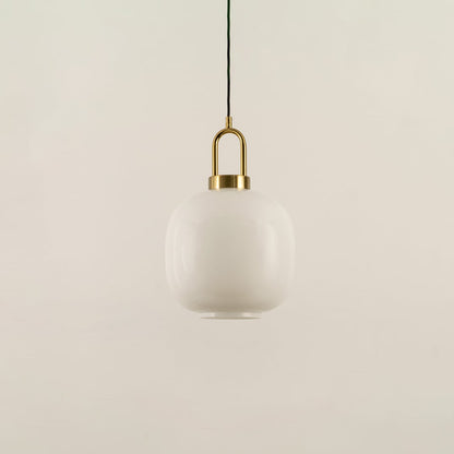 A gold and white glass pendant light with lights off on a white background highlighting its smooth rounded glass shade and refined metal accents.