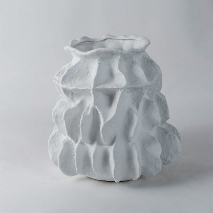Contemporary white ceramic vase with unique sculptural form and rough textured finish ideal for modern interior decoration.