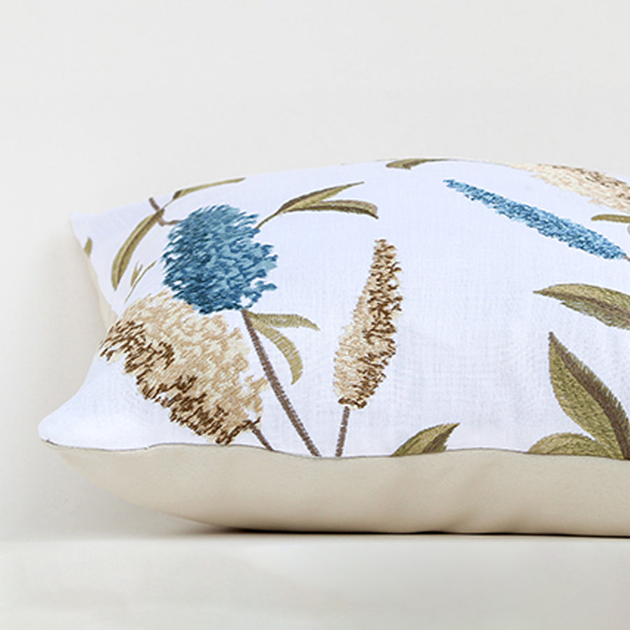 White cotton cushion cover with blue botanical leaf print showcasing soft cotton fabric texture and premium stitched finish.