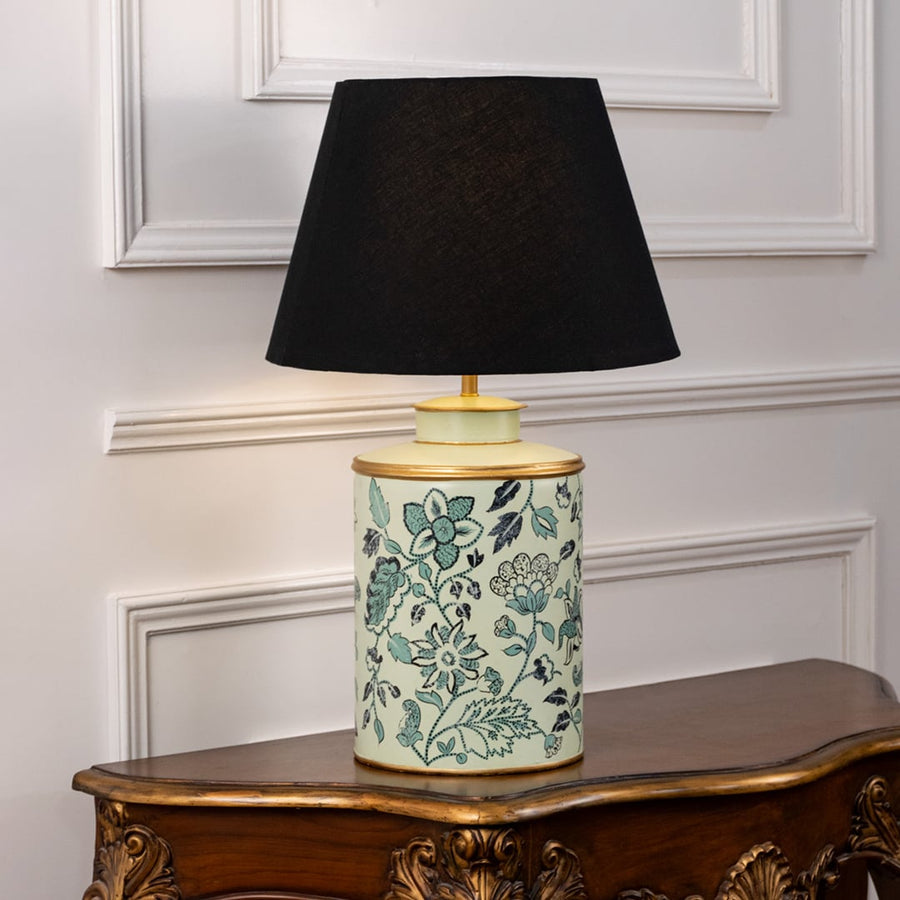 Table lamp on white background showcasing teal floral patterned ceramic base combined with an elegant black fabric lampshade.