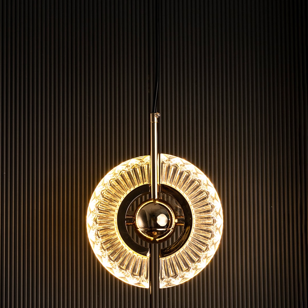 Crystal halo pendant light turned off with clear glass ring and golden accent visible against dark background for luxury interior style.