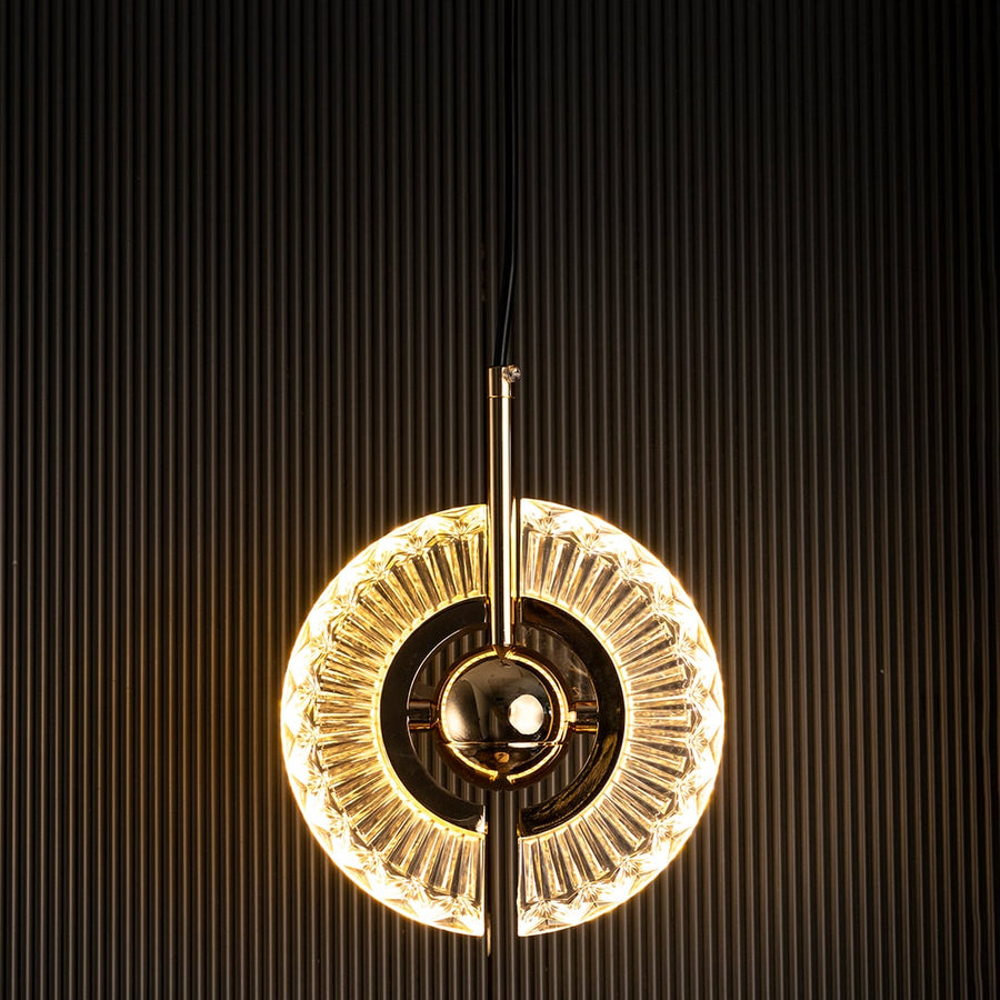 Crystal halo pendant light turned off with clear glass ring and golden accent visible against dark background for luxury interior style.