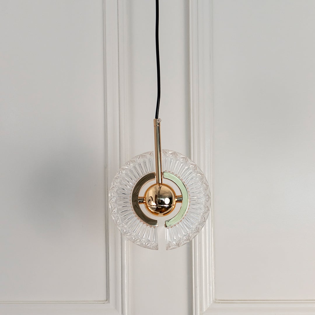 Crystal halo pendant light turned off featuring circular glass design and metallic brass detailing against white background.