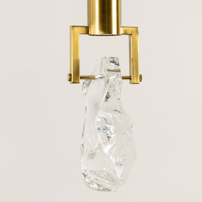 Gold metal pendant light closeup featuring crystal accent detailing and premium luxury lighting craftsmanship quality.