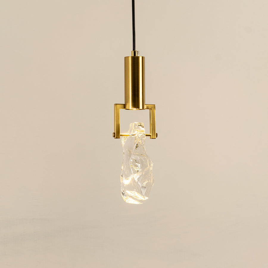 Elegant gold metal pendant light with crystal bulb holder for stylish kitchen and luxury interior decor styling.