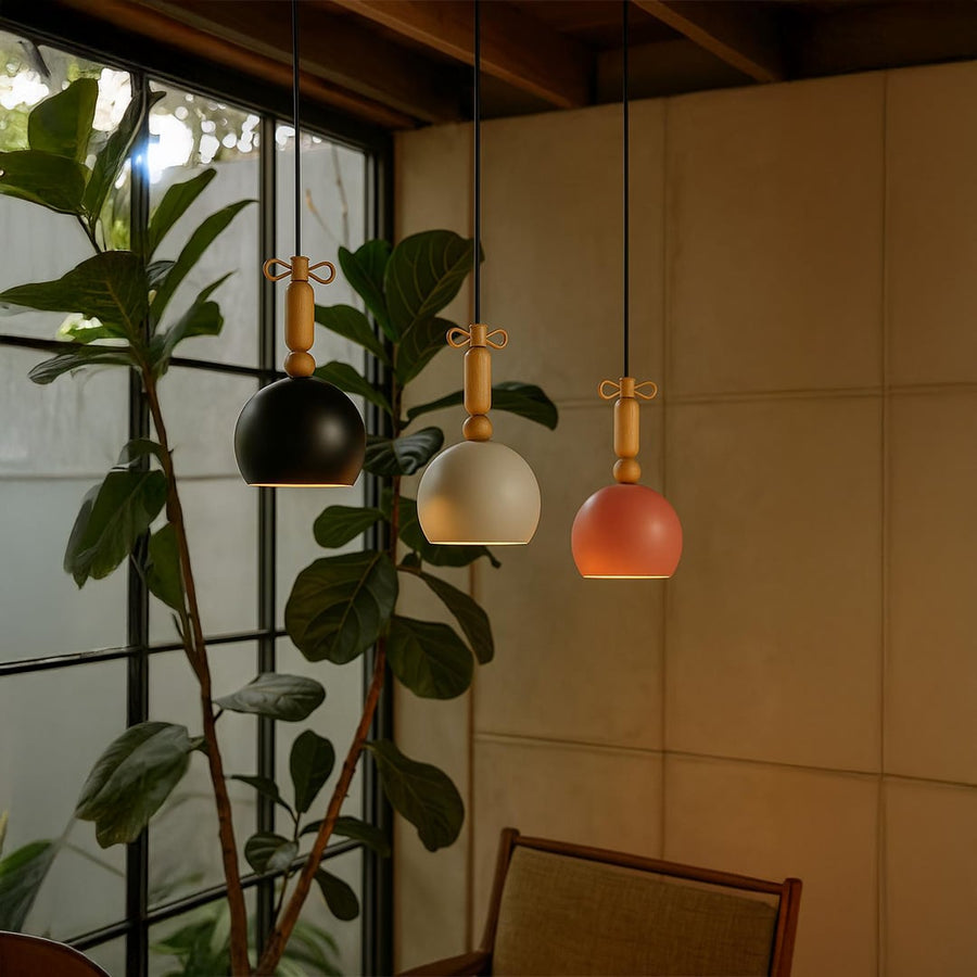 Black metal lantern wall light with clear glass shade and exposed bulb shown off on white background for modern home decor.