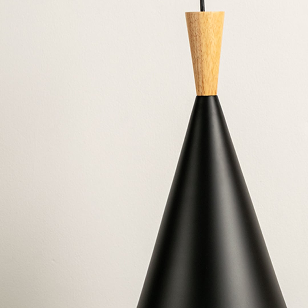 Close up of pendant light showing its sleek black cone shade and wooden accent designed for contemporary interiors.