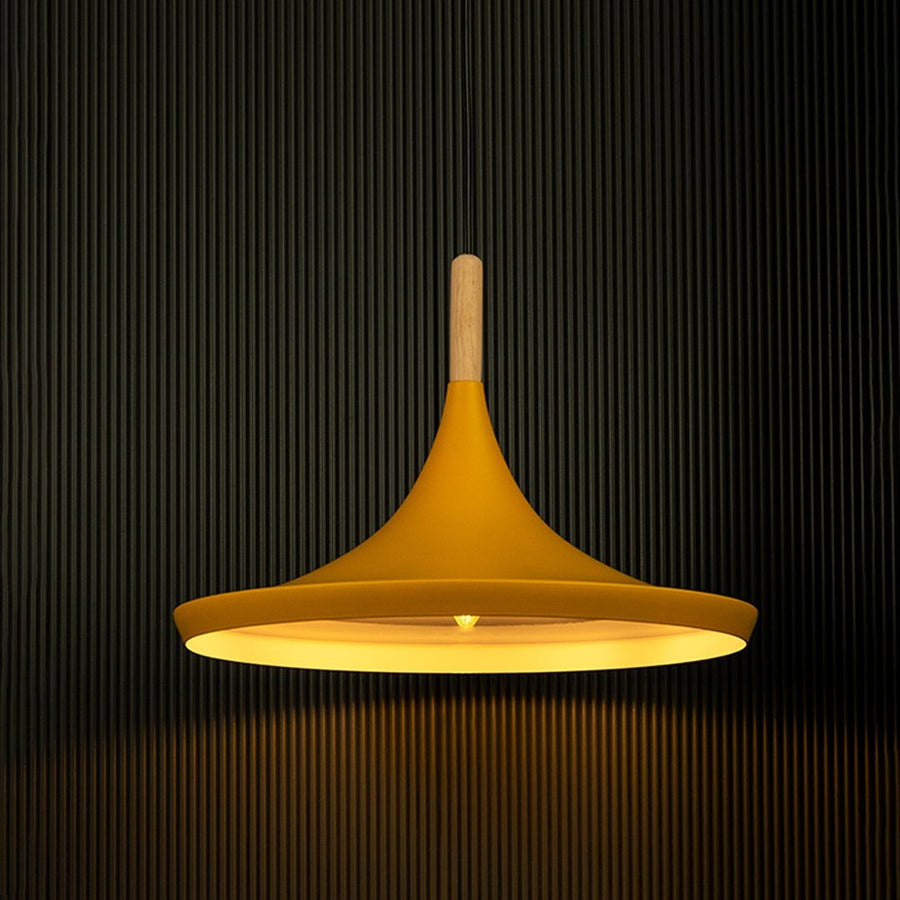 Yellow pendant light shining against a black background emphasizes its sleek design and natural wood detail.