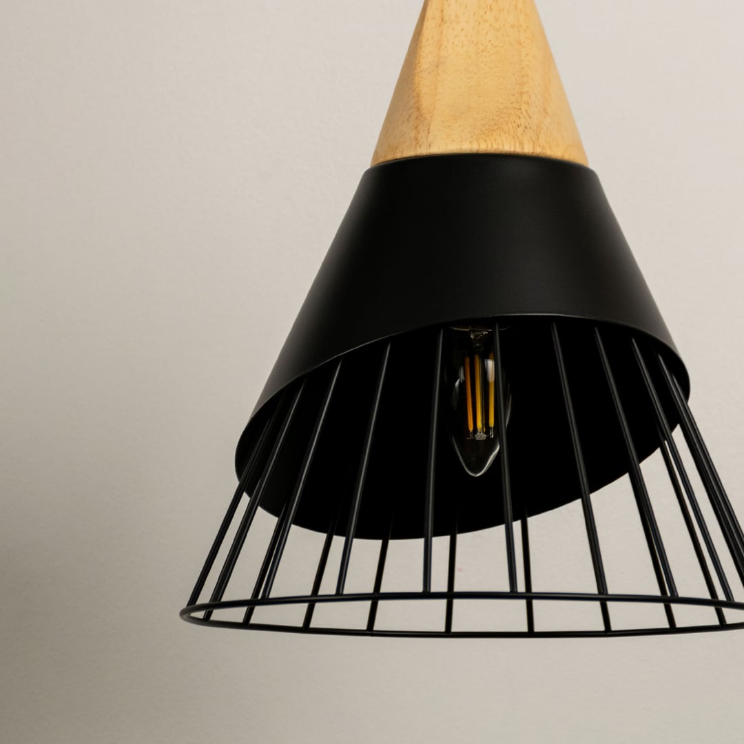 Detailed view of black metal cage pendant light with wood top highlighting stylish industrial design.