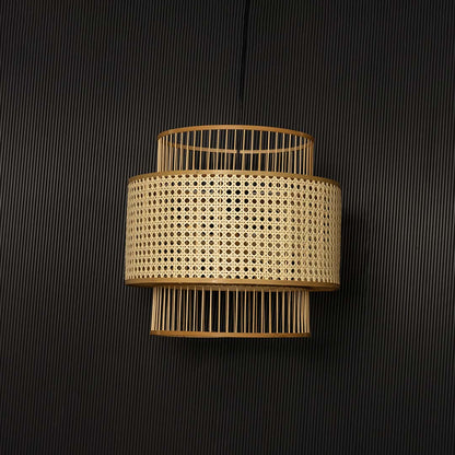 Natural rattan pendant light displayed off on black background showing elegant handcrafted layered design.