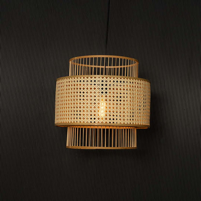 Boho rattan pendant light glowing softly through woven cane shade creating warm ambience on black background.