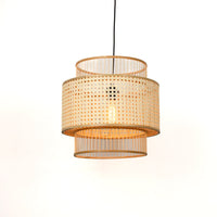 Round bamboo pendant light with woven shade illuminated for elegant boho ceiling decor style.