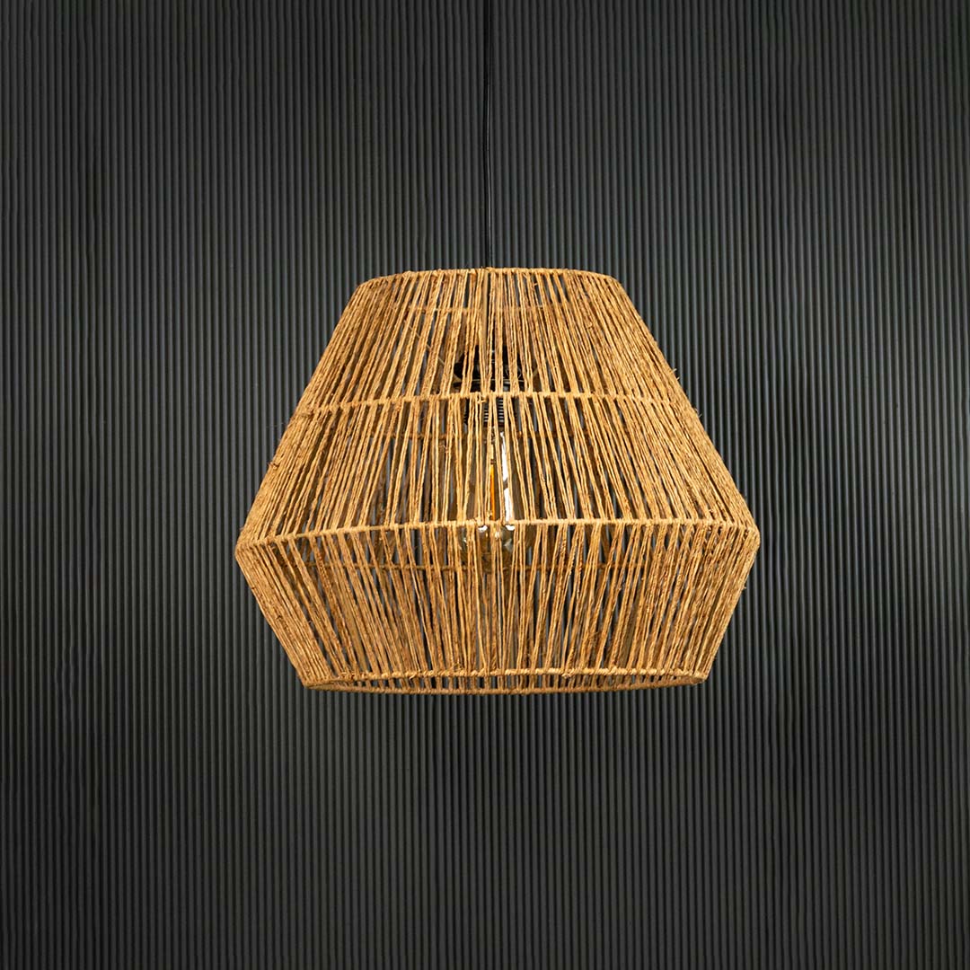 Natural jute pendant ceiling light switched off on back background for rustic bohemian dining and living room decor.