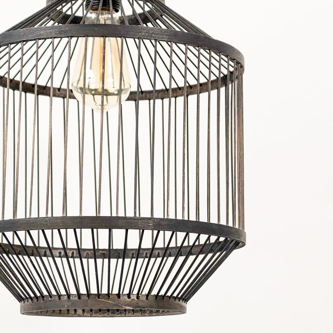 Closeup of wire pendant light showing fine metal detailing and exposed filament bulb for an artistic modern touch.