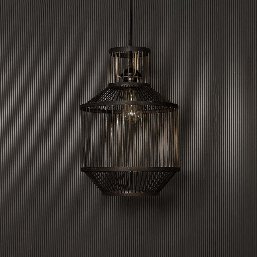 Industrial wire pendant light on dark background emphasizing its matte metal finish and modern craftsmanship.