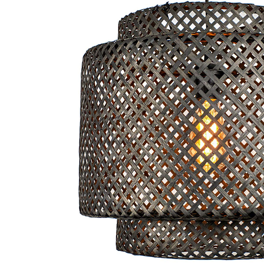 Closeup of black woven rattan pendant light showcasing intricate texture and handcrafted artisan details.