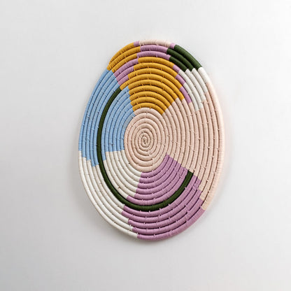 A side angle view of the woven wall plate against a white background emphasizing the raised texture and layered weaving details with rich handcrafted character.